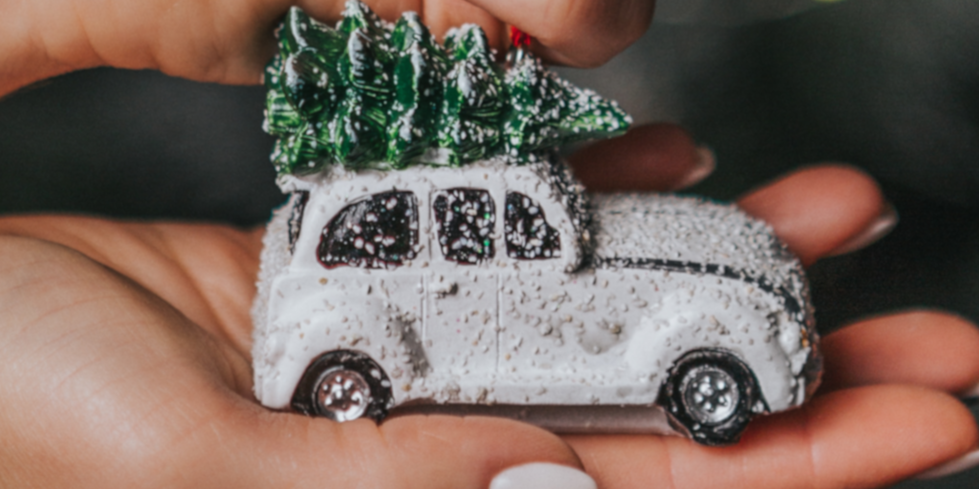 ornamental christmas decoration shaped as car with xmas tree on roof