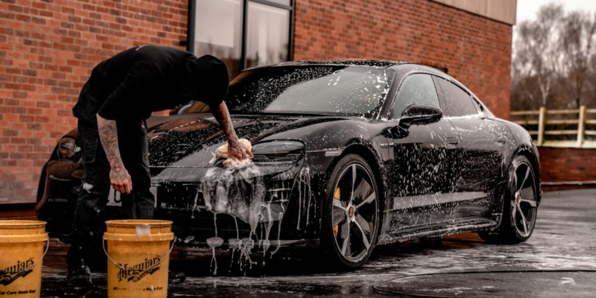 man washing car